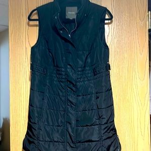 Maurice’s longer style black puff vest. Has zippers on hem as well. Size M